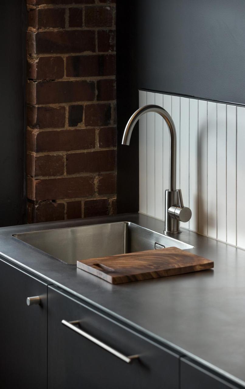 The Chamberson Hotel Dunedin Luaran gambar A kitchen sink with a wooden cutting board
